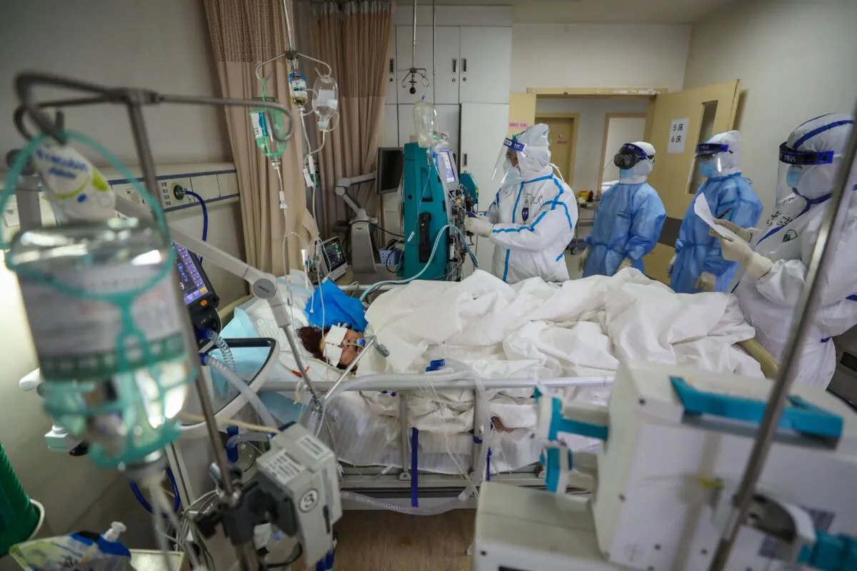 Medical staff are checking on a COVID-19 coronavirus patient at the Red Cross hospital in Wuhan, China on March 6, 2020. (STR/AFP via Getty Images)