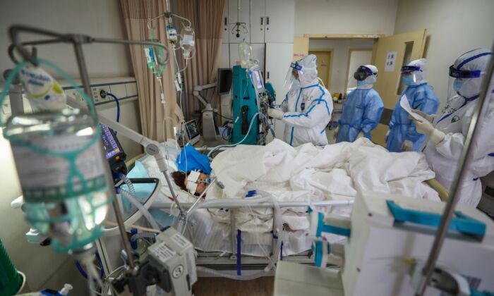 Medical staff are checking on a COVID-19 coronavirus patient at the Red Cross hospital in Wuhan, China on March 6, 2020. (STR/AFP via Getty Images)