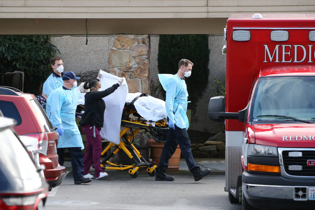 A patient is transferred into an ambulance at the Life Care Center in Kirkland, Washington on March 7, 2020. (Karen Ducey/Getty Images)