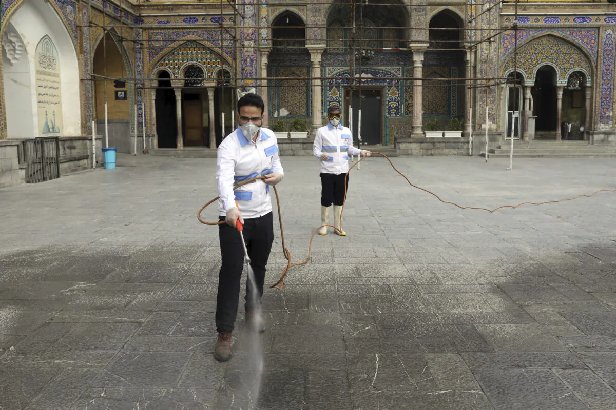 Workers disinfect the shrine of the Shiite Saint Imam Abdulazim to help prevent the spread of the new coronavirus in Shahr-e-Ray, south of Tehran, Iran, March, 7, 2020. (AP Photo/Ebrahim Noroozi)