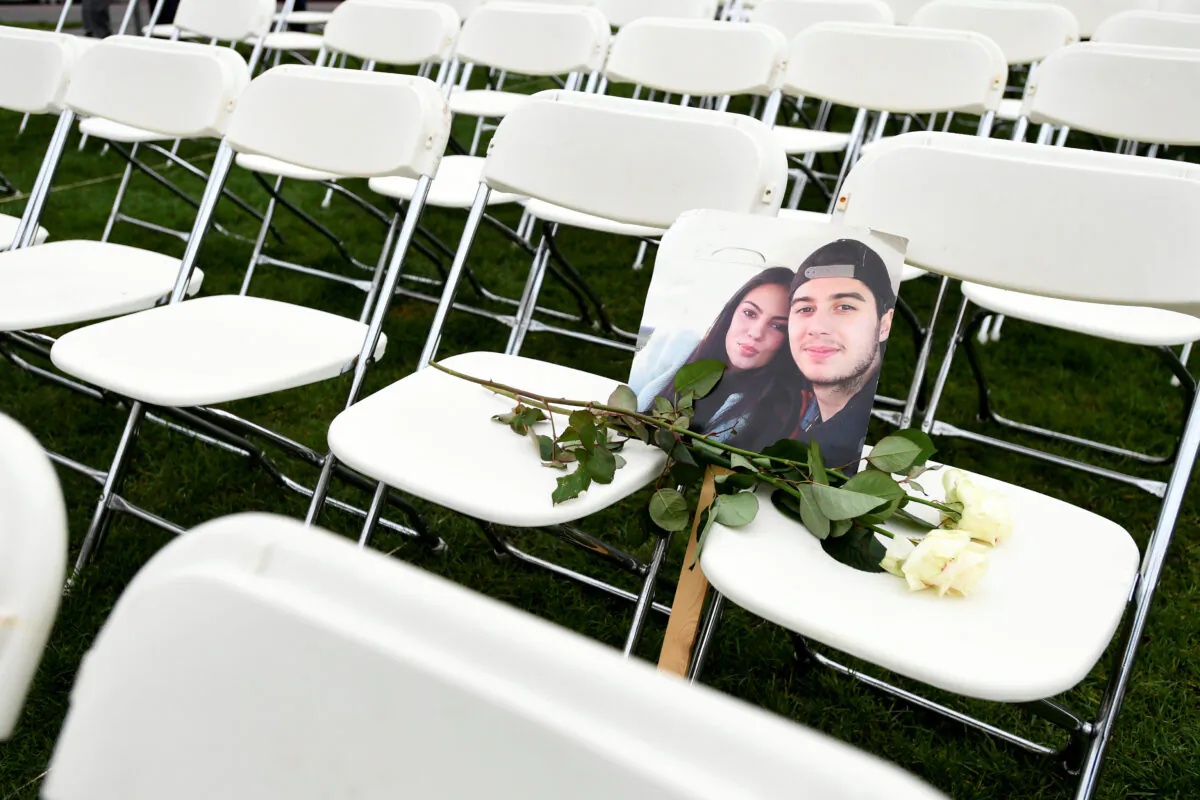 A picture of victims of the MH17 crash rests on empty chairs during a protest outside the Russian Embassy in The Hague, Netherlands, on March 8, 2020. (Piroschka van de Wouw/Reuters)