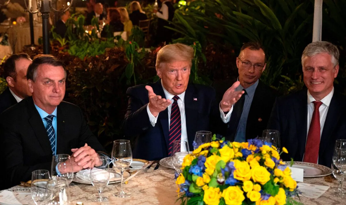 President Donald Trump (C) speaks with Brazilian President Jair Bolsonaro (L), alongside U.S. National Security Advisor Robert O'Brien (R) during a diner at Mar-a-Lago in Palm Beach, Fla., on March 7, 2020. (Jim Watson/AFP via Getty Images)