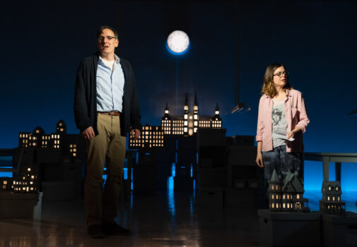 man and woman singing in cityscape