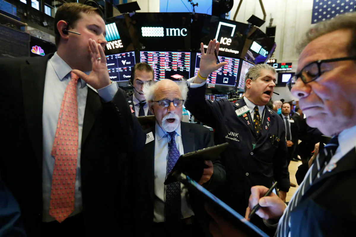 New York Stock Exchange Floor Governor Brendan Connolly, left, works with traders Peter Tuchman, John Panin and Sal Suarino, second left to right, on the floor of the NYSE. (AP Photo/Richard Drew)