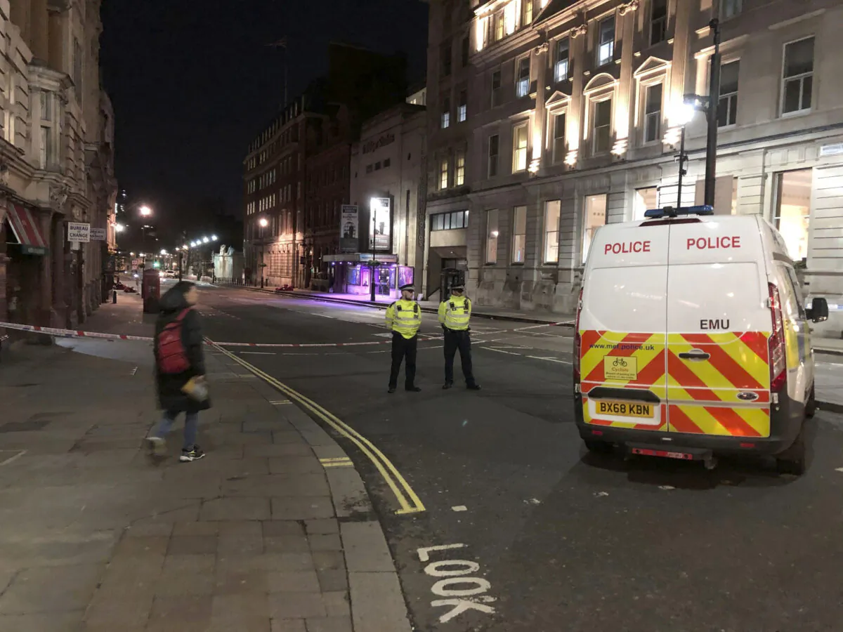 Police stand guard by a cordoned off area after an incident in Westminster, London, UK., on March 9, 2020. (Scott D'Arcy/PA via AP)