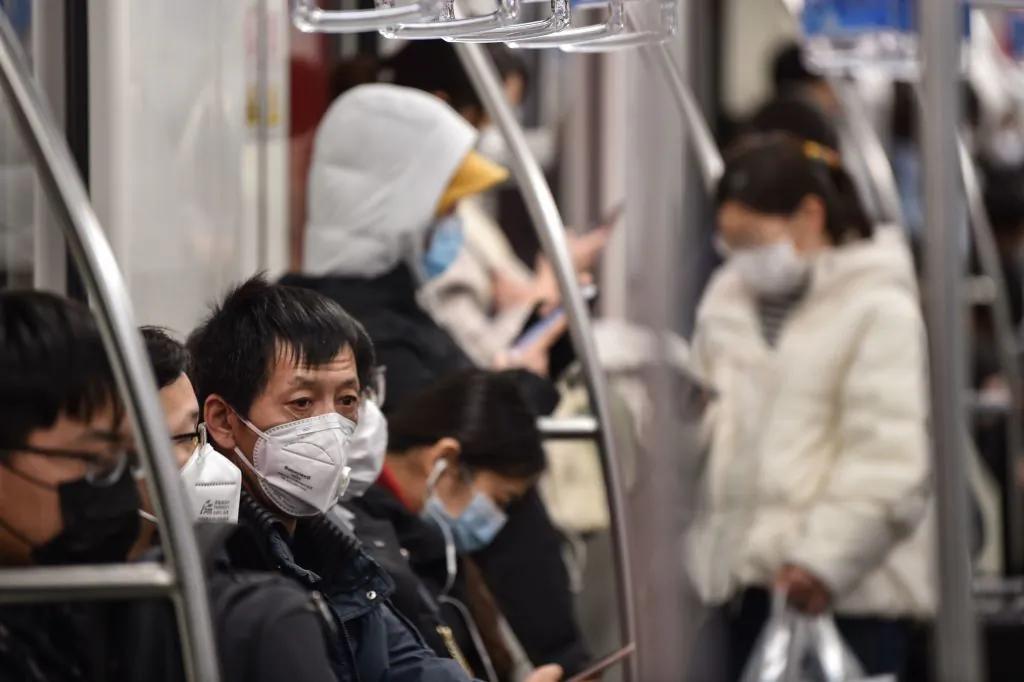 Passengers wearing face masks travel on a subway train in Shanghai on March 5, 2020. (Hector Retamal/AFP via Getty Images)