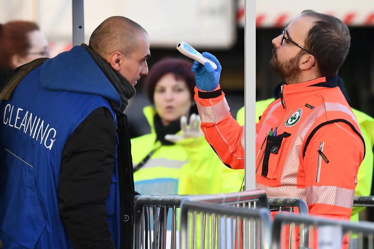 Health staff check the body temperatures of cleaning staff arriving at the Juventus stadium before a football match in Turin, Italy, on March 8, 2020. (Vincenzo Pinto/AFP via Getty Images)