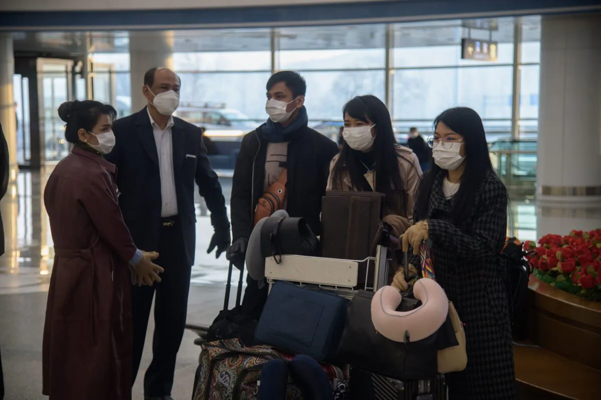 Foreign diplomats, embassy staff, and their families check-in for a flight to Vladivostok at Pyongyang International Airport on March 9, 2020. (Kim Won Jin/AFP/Getty Images)