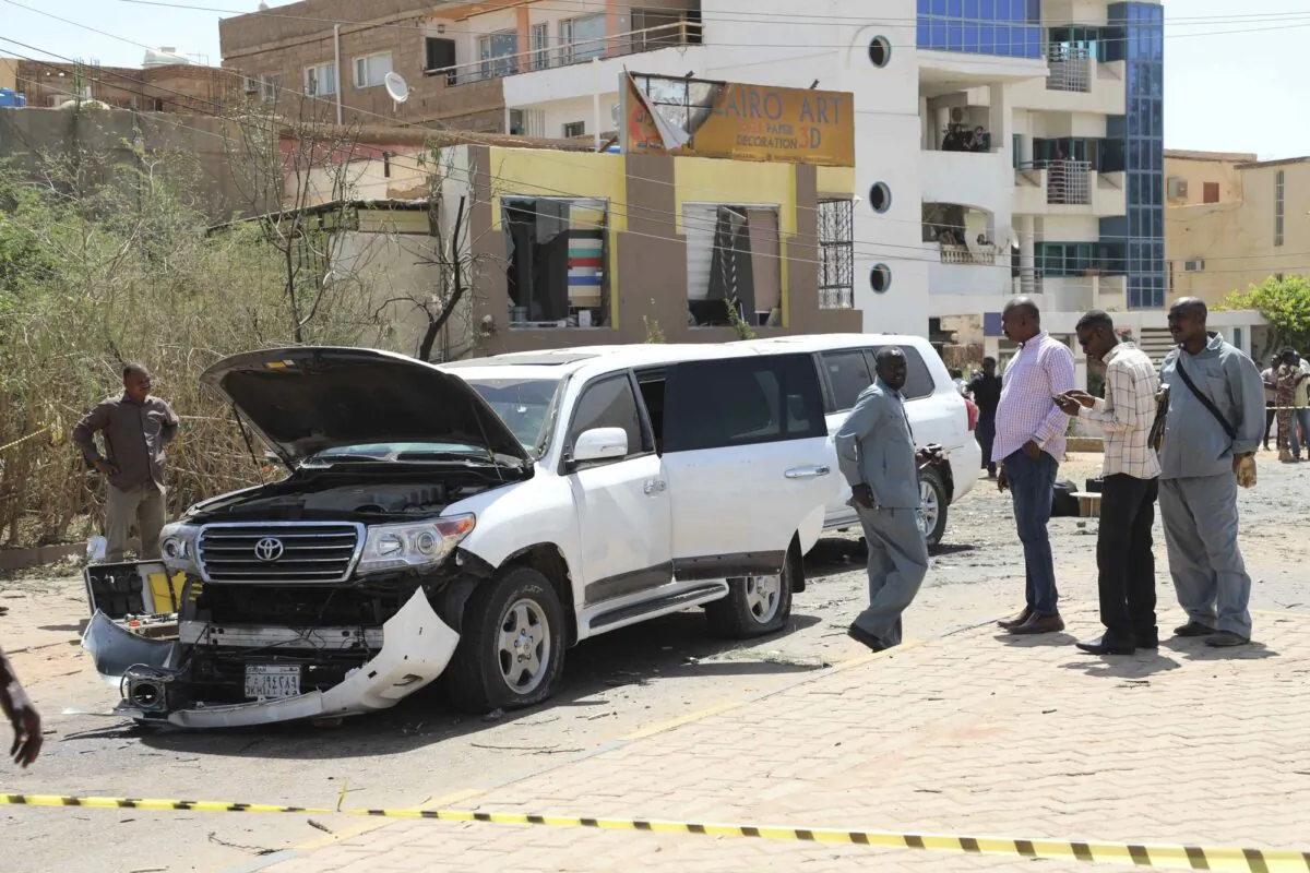 Sudanese policemen stand around vehicles that were part of Prime Mister Abdalla Hamdok's motorcade in Khartoum, Sudan, on March 9, 2020. (Marwan Ali/AP Photo)