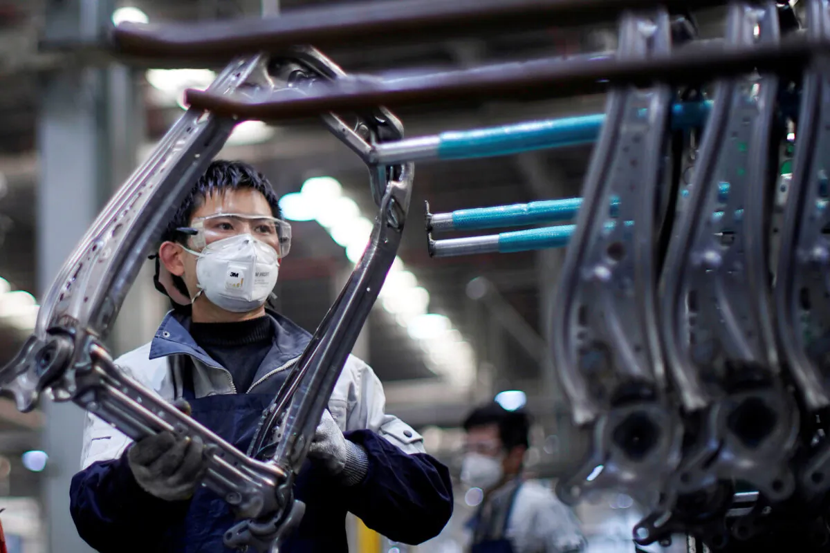 An employee wearing a face mask works on a car seat assembly line at Yanfeng Adient factory in Shanghai, China, as the country is hit by an outbreak of a novel coronavirus, on Feb. 24, 2020. (Aly Song/Reuters)