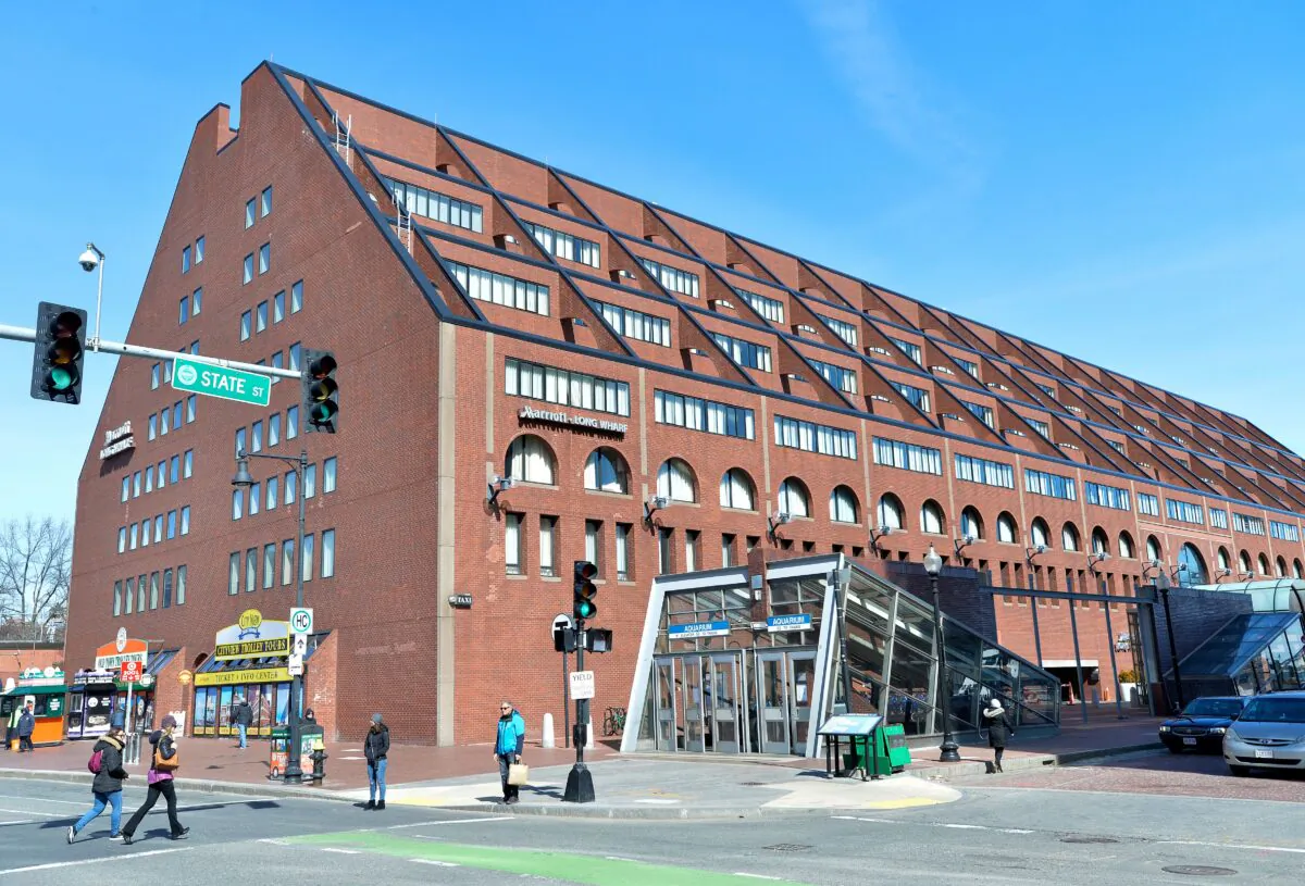 People walk past the Marriot Long Wharf Hotel in Boston, Mass., on March 7, 2020. (Joseph Prezioso/AFP via Getty Images)