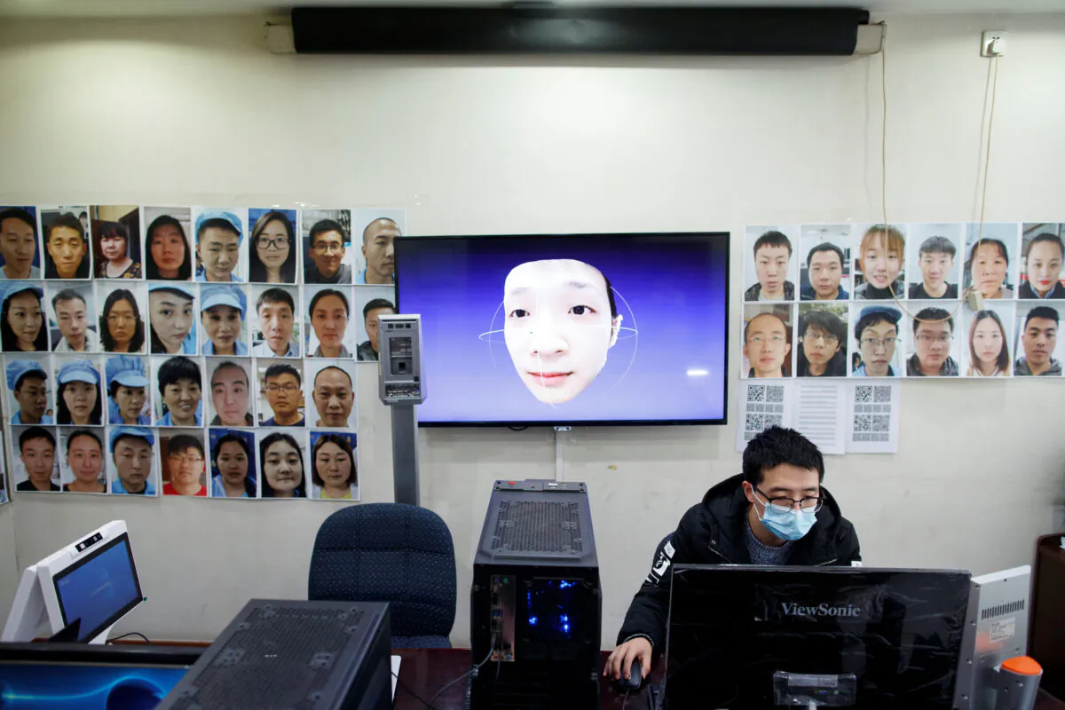A software engineer works on a facial recognition program that identifies people when they wear a face mask at the development lab of a Chinese electronics manufacturer in Beijing, as the country is hit by an outbreak of the coronavirus pandemic, on March 6, 2020. (Thomas Peter/Reuters)
