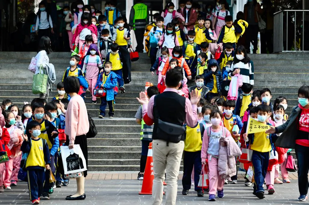 Children wearing face masks leave their elementary school at the end of the day in Xindian district, New Taipei City on March 3, 2020. (Sam Yeh/AFP via Getty Images)