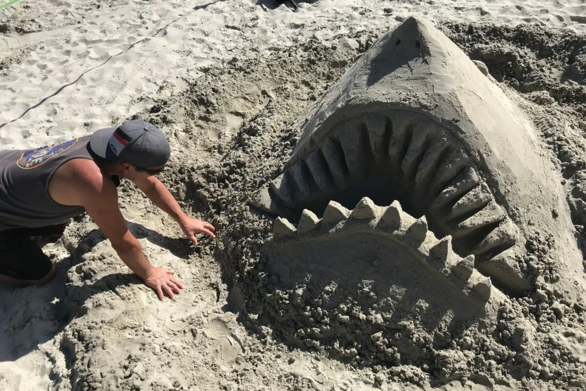 Philip Krajeski makes a shark sculpture at the Whale of a Sand sculpting competition that kicked off the Festival of Whales in Dana Point, Calif., on March 7, 2020. (Chris Karr/The Epoch Times)