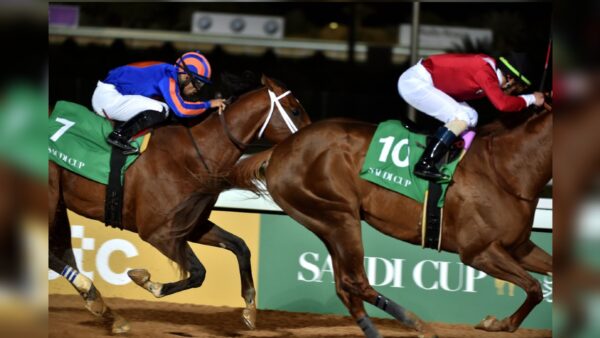 Jockey Luis Saez (L) rides his horse