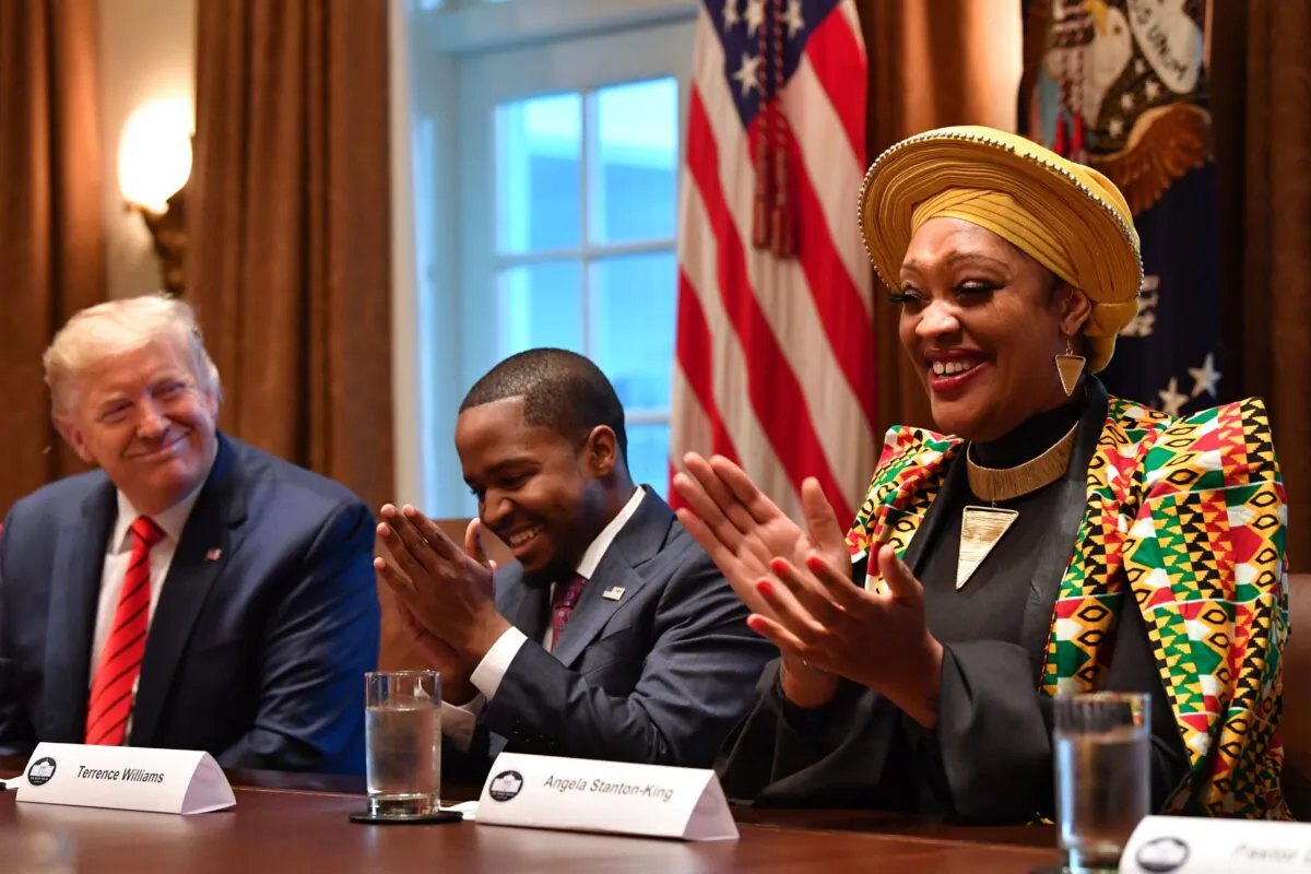 President Donald Trump next to Terrence Williams (C) and Angela Stanton-King during a meeting with African American leaders in the Cabinet Room of the White House in Washington on Feb. 27, 2020. (Nicholas Kamm/AFP via Getty Images)