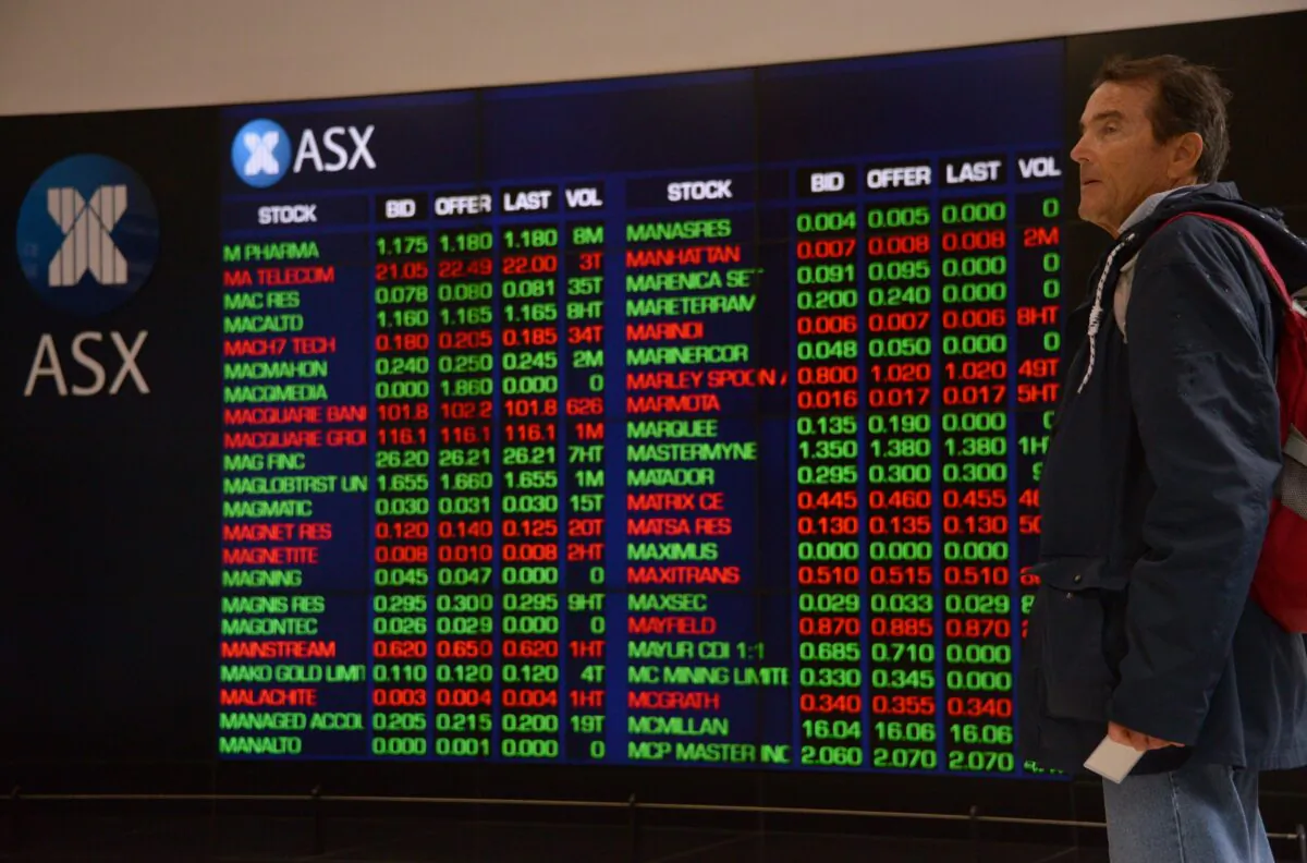 A visitor to the Australian Securities Exchange (ASX) looks at share prices on a big screen in Sydney on Oct. 11, 2018. (Peter Parks/AFP via Getty Images)