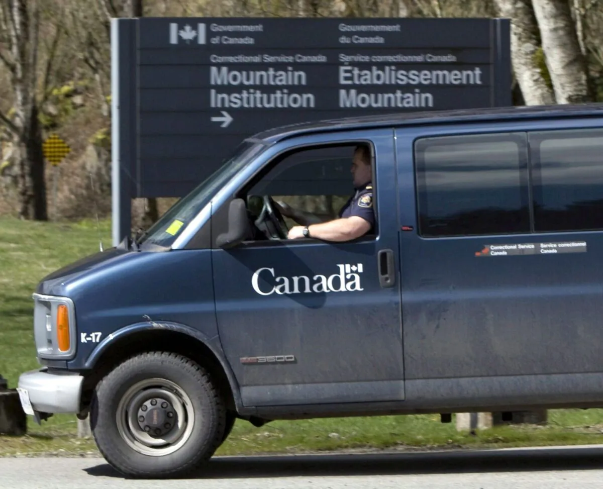 A correctional officer drives past the main gate to the Mountain Institution in Agassiz, B.C., in a file photo. (The Canadian Press/Jonathan Hayward)