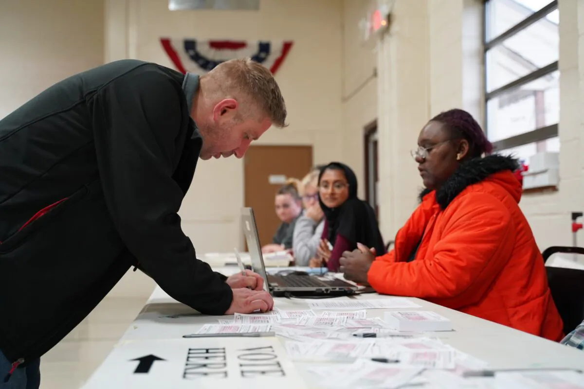 A voter fills out a ballot selection form at the voting center in Fitzgerald Recreation Center in Warren, Mich., on March 10, 2020. (Cara Ding/The Epoch Times)
