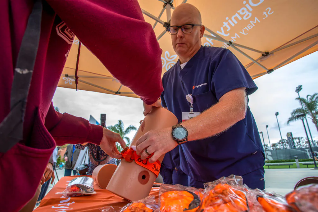 Nurse Terry Liddell shows a student how to apply a tourniquet as St. Mary Medical Center trauma nurses lead a Combat Application Tourniquet training demonstration at California State University, Long Beach, on May 9, 2019. (David McNew/Getty Images)