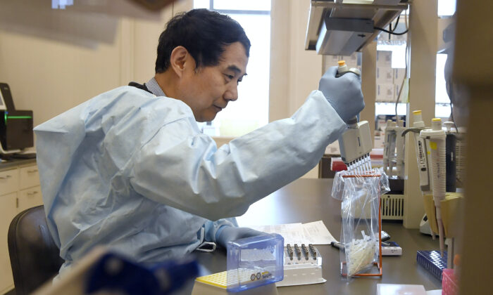 Microbiologist Xiugen Zhang runs a Polymerase Chain Reaction, or PCR, test at the Connecticut State Public Health Laboratory, in Rocky Hill, Conn., on March 2, 2020.  (Jessica Hill/File/AP Photo)