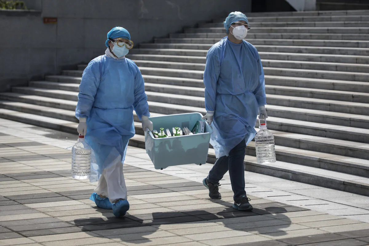 Medical workers carry a box in Wuhan, Hubei Province, China, on March 10, 2020. (Stringer/Getty Images)