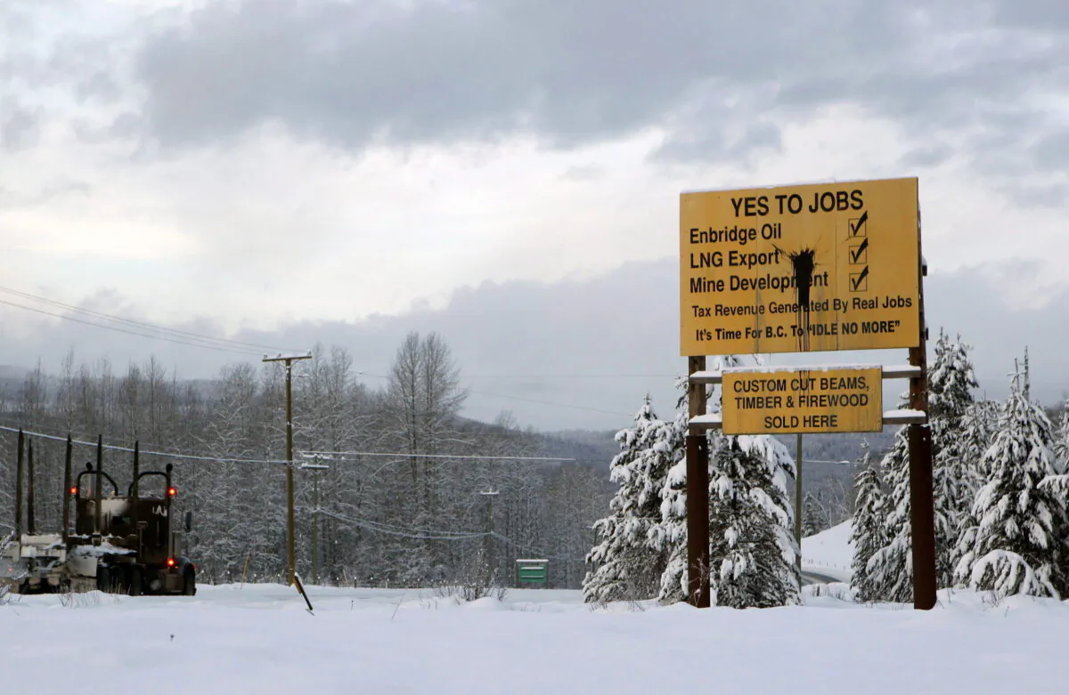 Signage in favour of resource development is seen along Yellowhead Highway near Telkwa in northern British Columbia on Jan. 10, 2019. (The Canadian Press/Chad Hipolito)
