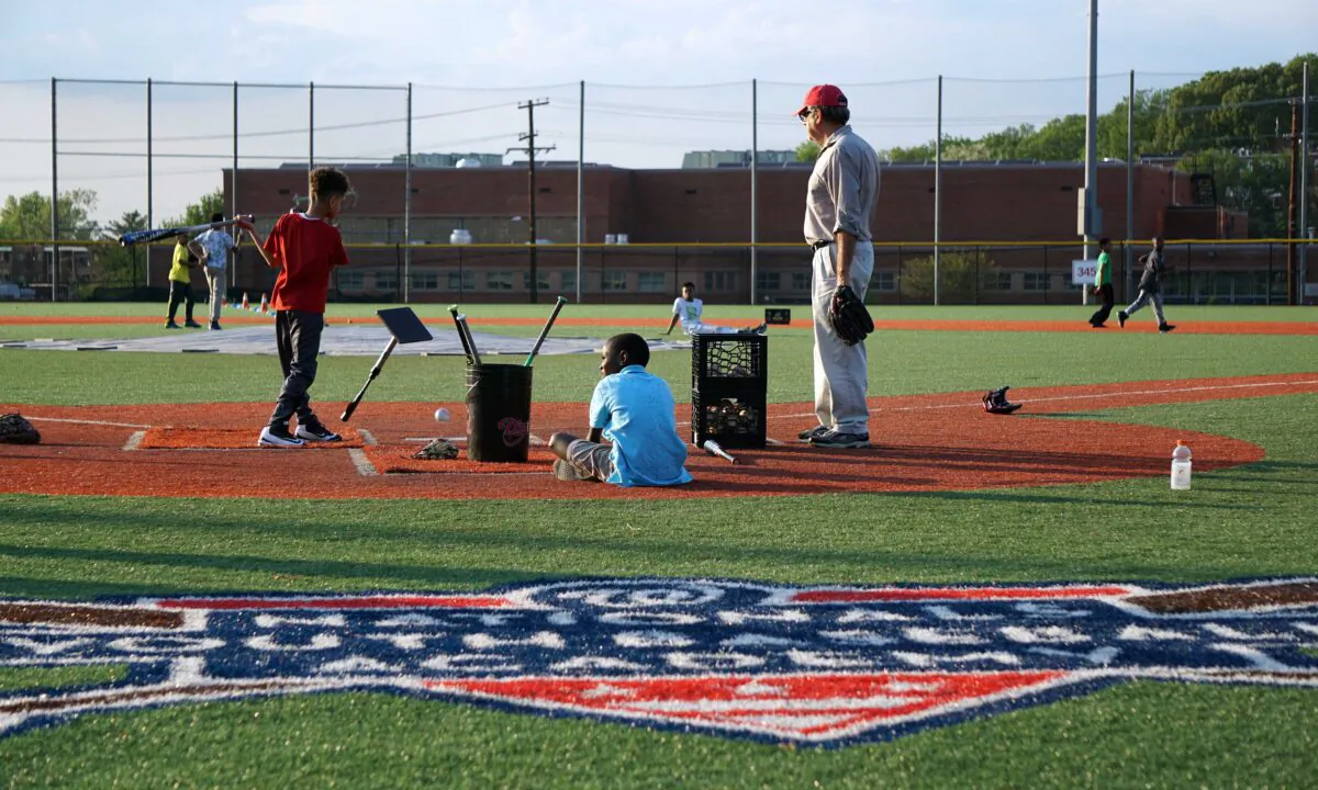 A coach watches children practice their baseball skills at the Nationals Youth Baseball Academy in Washington on May 7, 2018. (Katharyn Gillam/AFP via Getty Images)