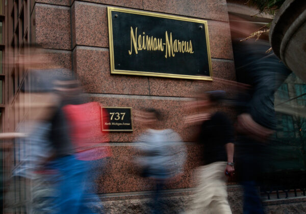 Pedestrians walk past a Neiman Marcus store