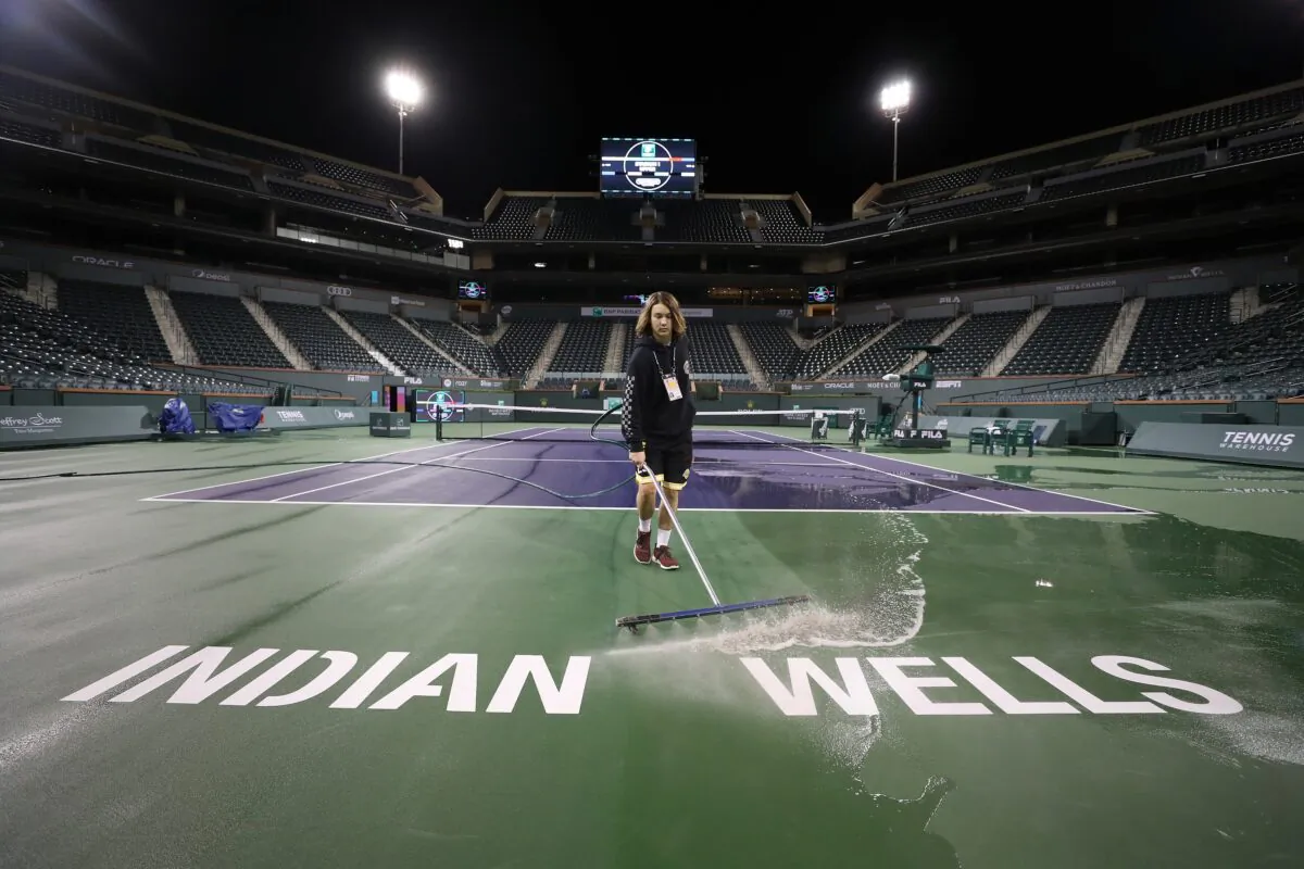 Courtmaster Jeffrey Brooker cleans the center court at the Indian Wells Tennis Garden in Indian Wells, California, on March 8, 2020. The BNP Paribas Open was cancelled as county officials declared a public health emergency when a case of coronavirus was confirmed in the area. (Al Bello/Getty Images)