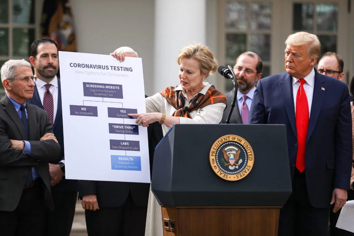 White House Coronavirus Response Coordinator Debbie Birx holds a chart showing how the coronavirus testing process will work, during a press conference led by President Donald Trump, who announced a national emergency with regard to the coronavirus in the White House Rose Garden in Washington on March 13, 2020. (Charlotte Cuthbertson/The Epoch Times)