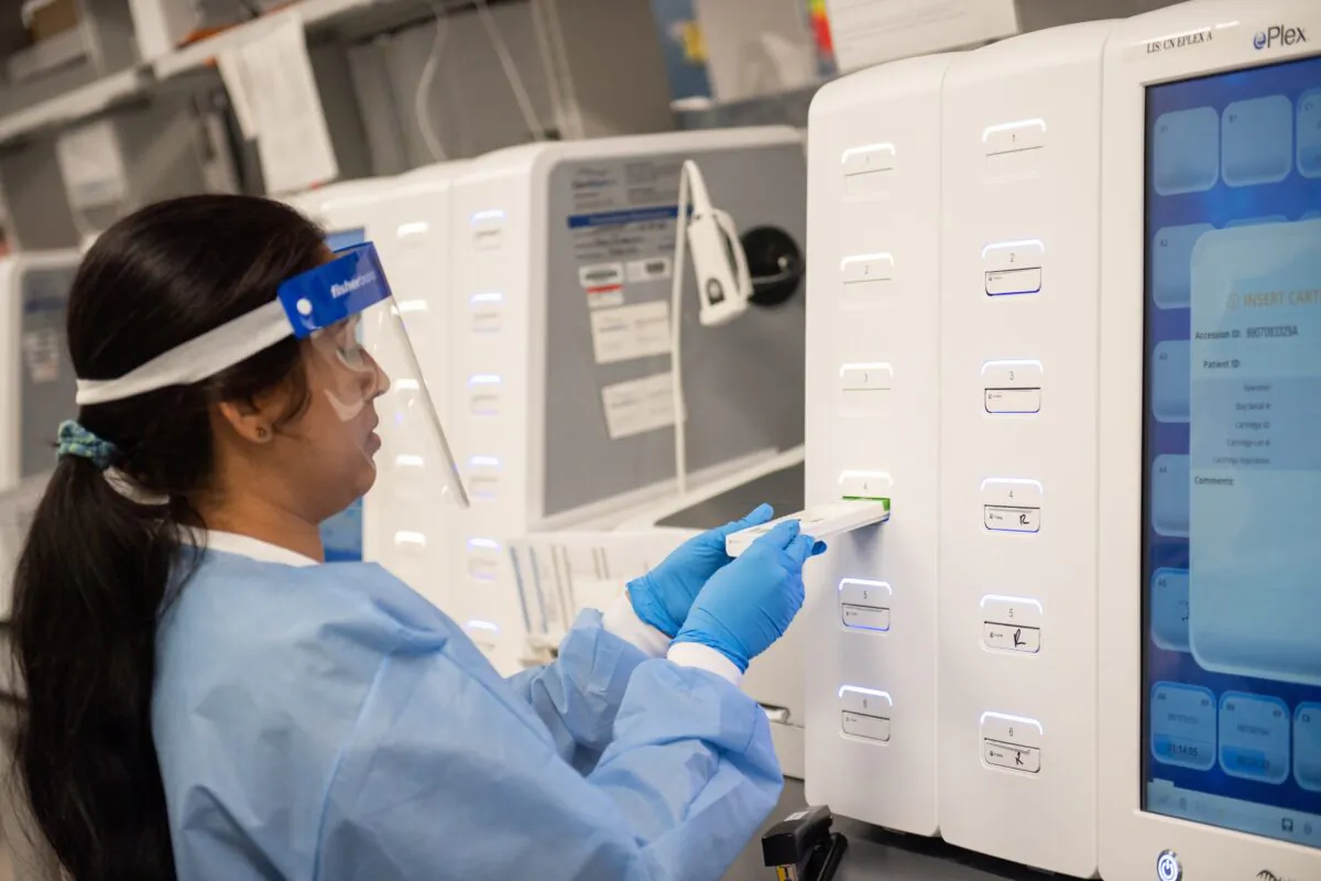 A lab technician begins semi-automated testing for COVID-19 at Northwell Health Labs in Lake Success, New York, on March 11, 2020. (Andrew Theodorakis/Getty Images)