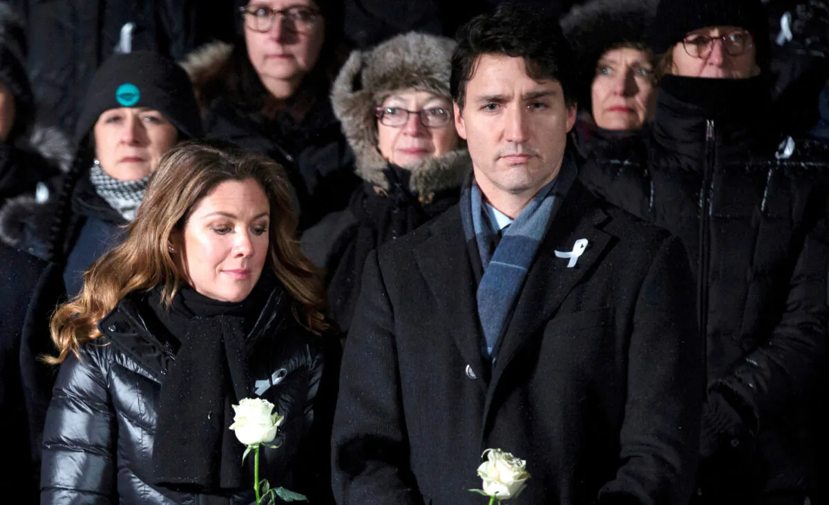 Prime Minister Justin Trudeau and his wife Sophie Grégoire Trudeau attend a vigil on top of Mount Royal in Montreal on Dec. 6, 2019. (Christinne Muschi/Reuters)