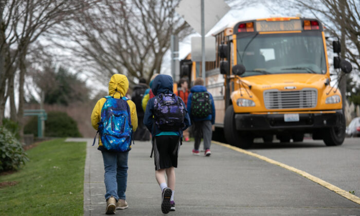 Students leave the Thurgood Marshal Elementary school after the Seattle Public School system was abruptly closed due to CCP virus fears in Seattle, Wash., on March 11, 2020.  (John Moore/Getty Images)