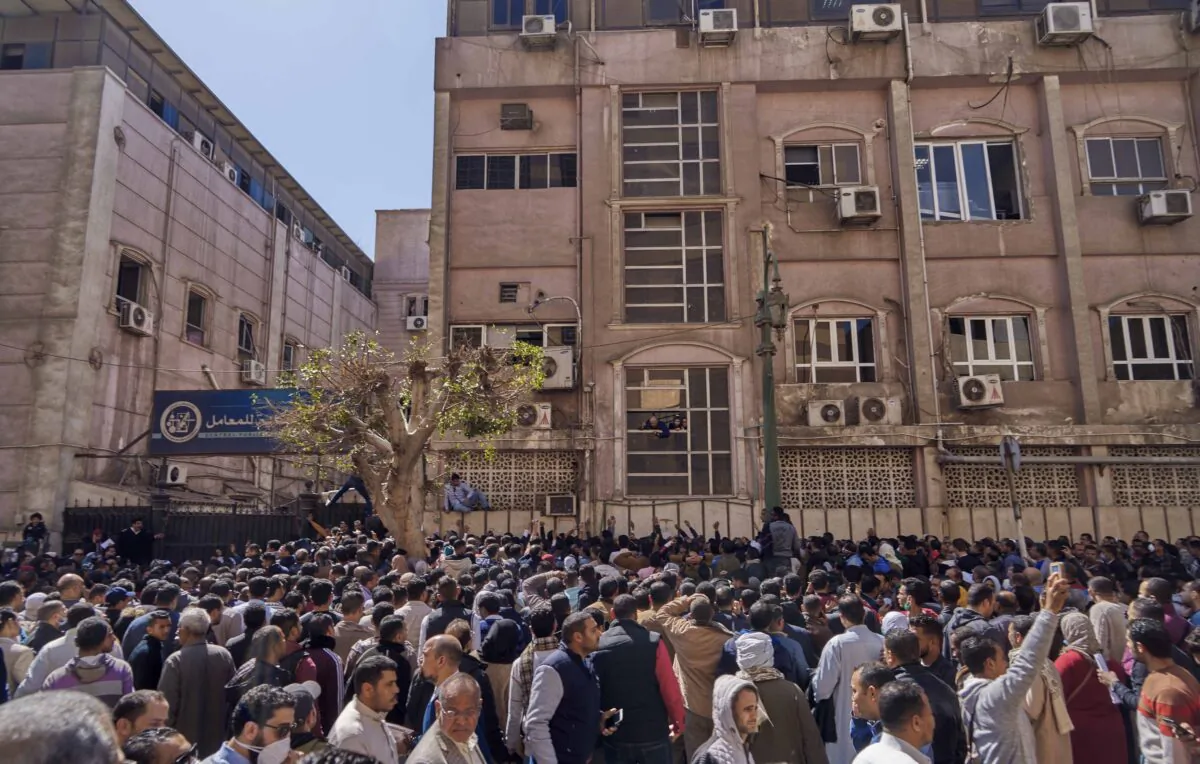 Egyptian citizens who are traveling abroad in the next 24 hours, wait for their turn to get a PCR Covid-19 test in front of the Central Public Health Laboratories, "a public department belongs to the Egyptian  Health Ministry." In Sheikh Rihan street, downtown Cairo, Egypt. Sunday, March 8, 2020. (AP Photo/Hamada Elrasam)