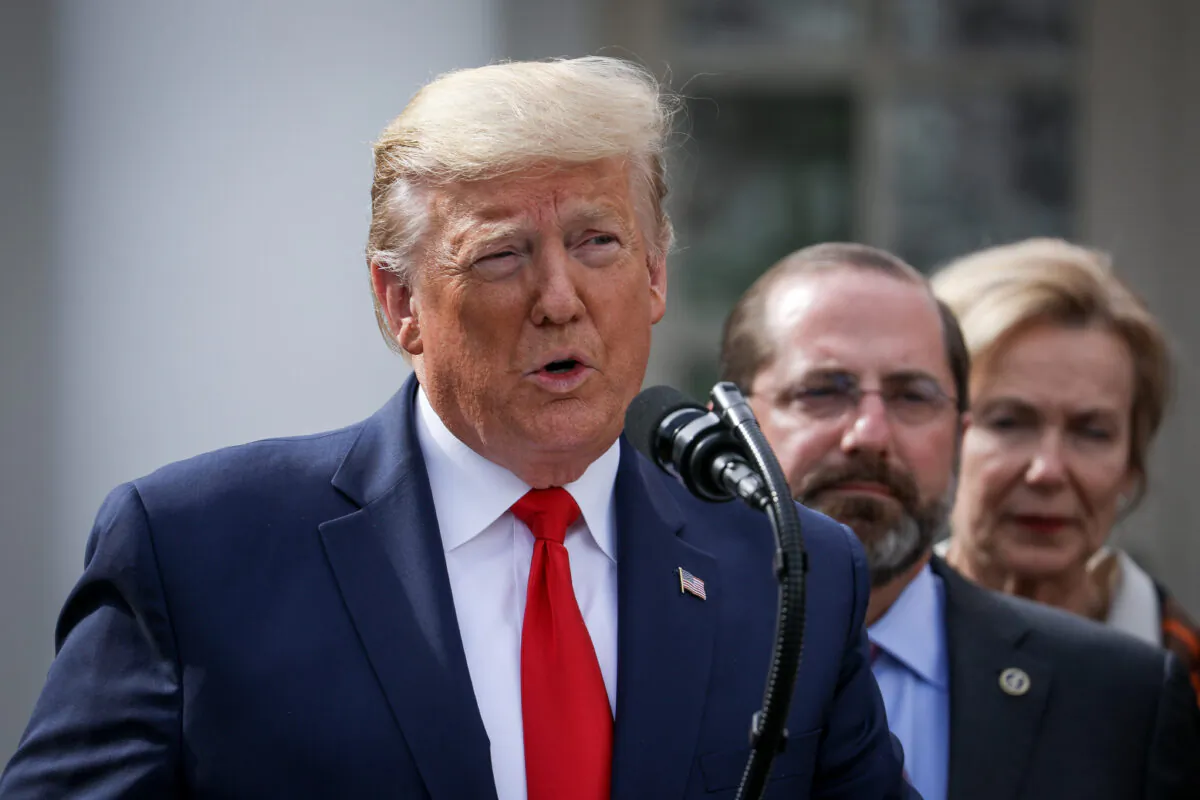 President Donald Trump, flanked by officials and business leaders, announces a national emergency with regard to the coronavirus in the White House Rose Garden in Washington on March 13, 2020. (Charlotte Cuthbertson/The Epoch Times)