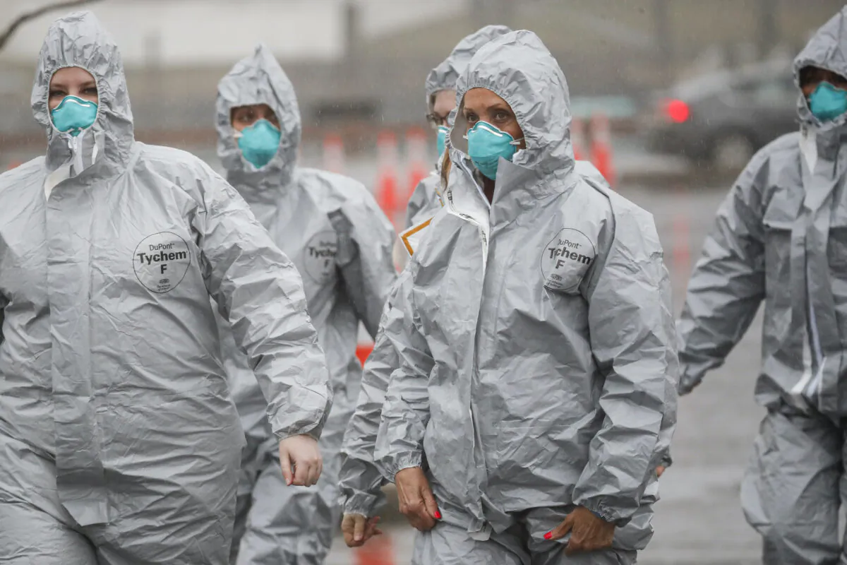 Medical personnel arrive to perform COVID-19 infection testing procedures at Glen Island Park in New Rochelle, N.Y., on March 13, 2020. (John Minchillo/AP Photo)