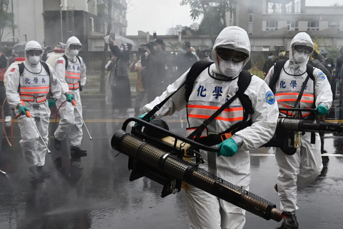 Soldiers from military chemical units take part in a drill organized by the New Taipei City government to prevent the spread of the COVID-19 coronavirus, in the Xindian District of New Taipei, Taiwan, on March 14, 2020. (Sam Yeh/AFP via Getty Images)