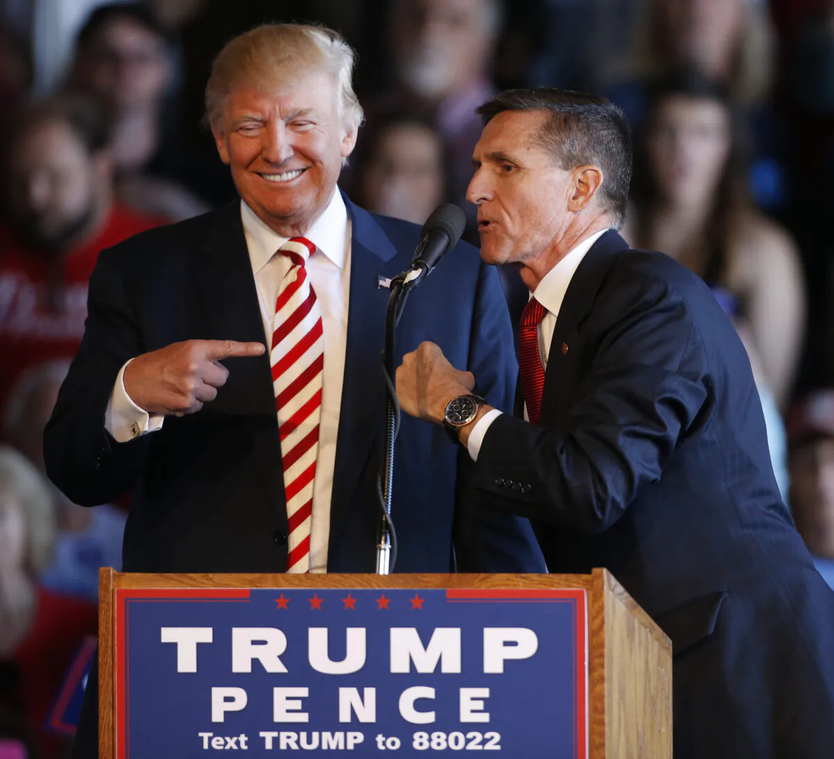 Republican presidential candidate Donald Trump (L) jokes with retired Gen. Michael Flynn at a rally at Grand Junction Regional Airport in Grand Junction, Colo., on Oct. 18, 2016. (George Frey/Getty Images)