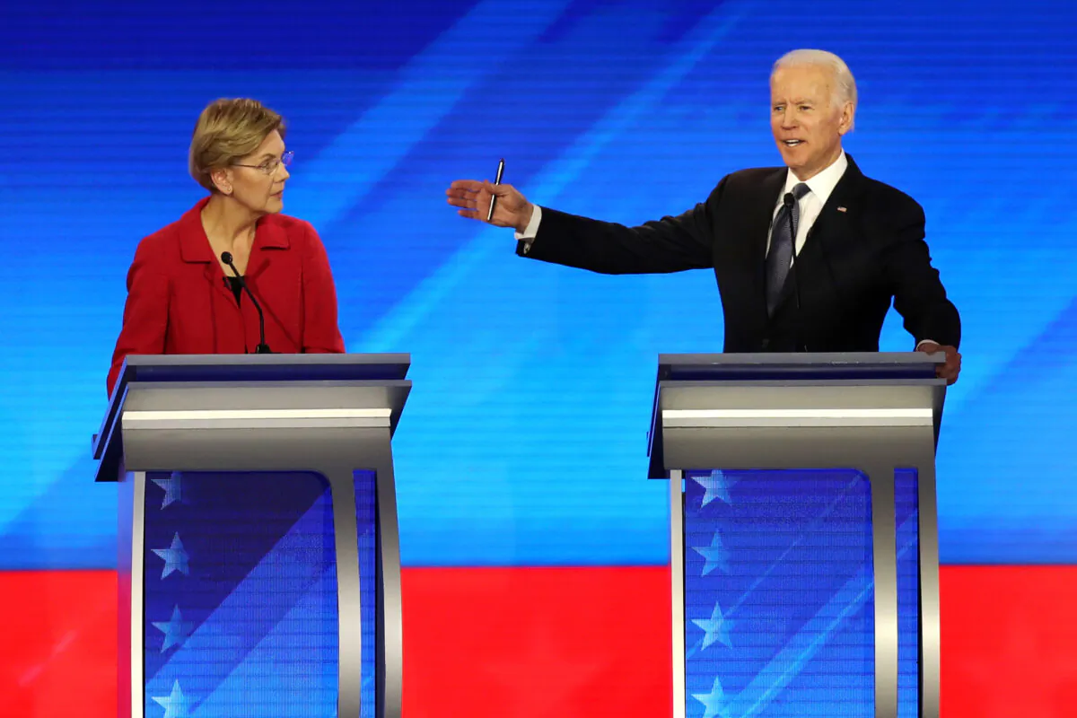 Democratic presidential candidates Sen. Elizabeth Warren (D-Mass.) and former Vice President Joe Biden (R) participate in the Democratic presidential primary debate in the Sullivan Arena at St. Anselm College in Manchester, N.H., on Feb. 7, 2020. (Joe Raedle/Getty Images)