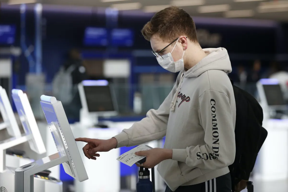 Passenger checks in using a touchscreen at JetBlue's terminal in John F. Kennedy International Airport in New York City on March 14, 2020. (Kathy Willens/AP Photo)