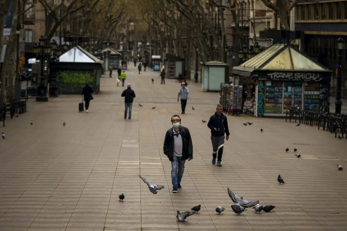 People walk along La Ramblas in Barcelona, Spain, on March 15, 2020. (Emilio Morenatti/AP Photo)