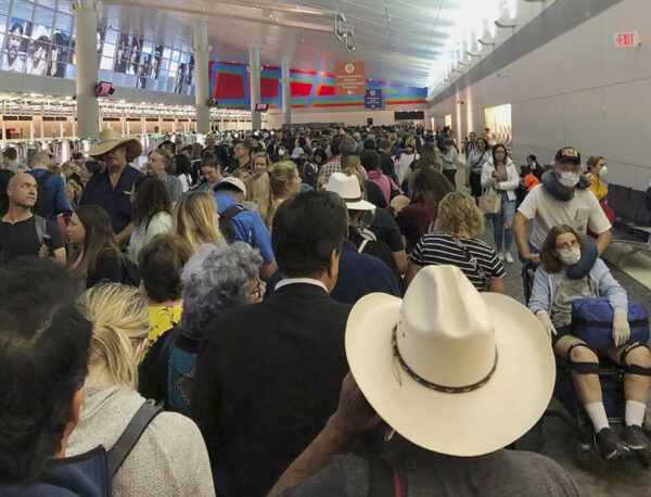 People wait in line to go through the customs at airport