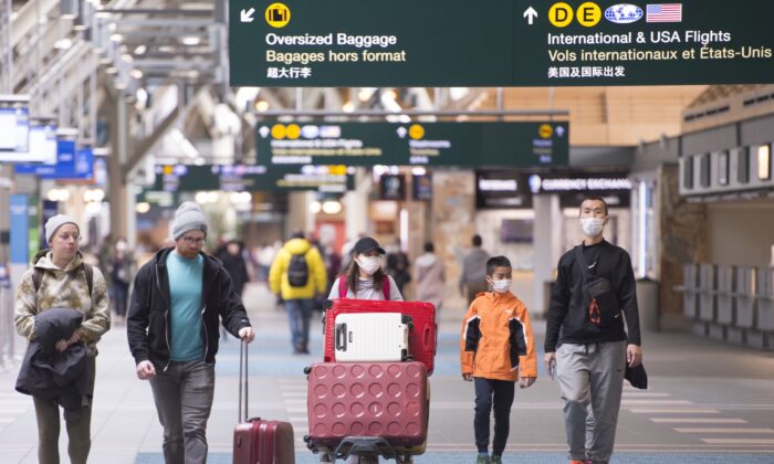 Travellers are seen astatine  Vancouver International Airport successful  Richmond, B.C., connected  March 13, 2020.  (The Canadian Press/Jonathan Hayward)
