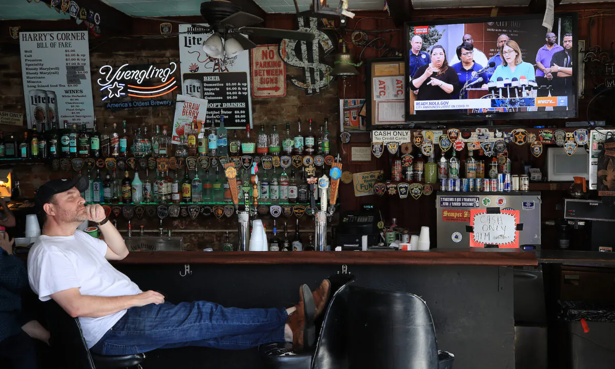 A man watches a press briefing from Mayor LaToya Cantrell in a bar in the French Quarter in New Orleans, Louisiana, on March 15, 2020. (Chris Graythen/Getty Images)