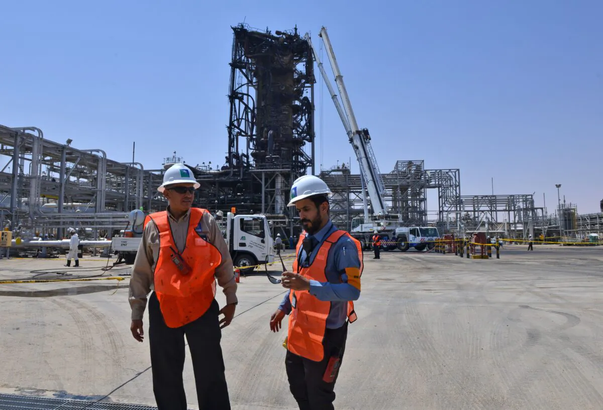 Employees of Aramco oil company stand near a heavily damaged installation in Saudi Arabia's Khurais oil processing plant on Sept. 20, 2019. (Fayez Nureldine/AFP via Getty Images)