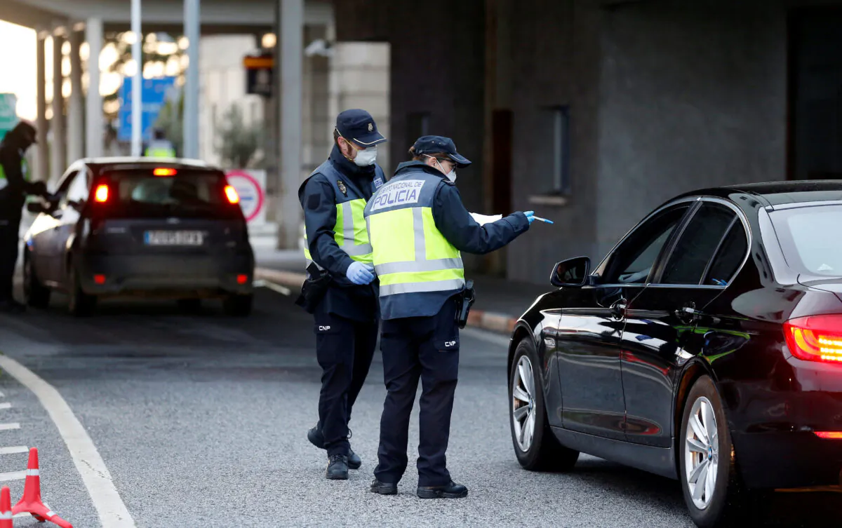 Spanish police officers check a car at the border between Portugal and Spain, following an order from the Spanish government to set up controls at its land borders over coronavirus, in Vilar Formoso, Portugal, on March 17, 2020. (Rafael Marchante/Reuters)