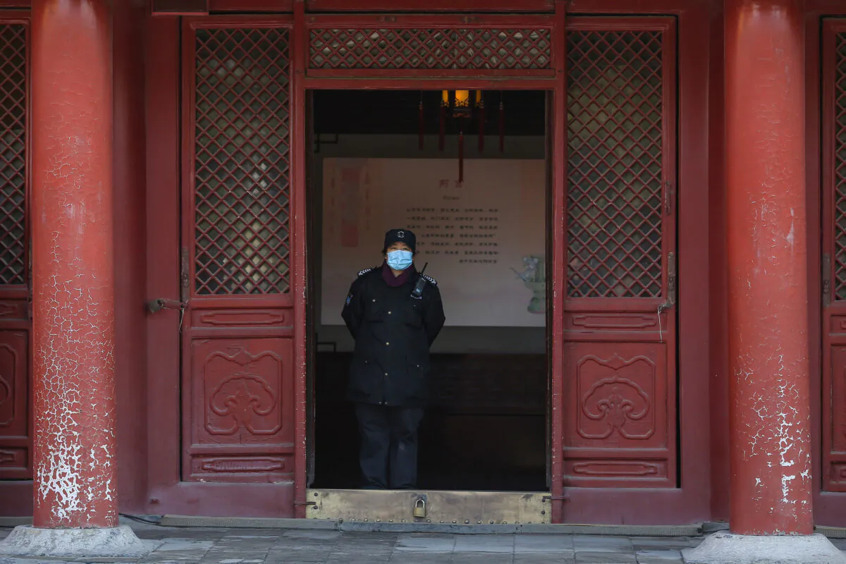 A security guard wearing a face mask at the Imperial Palace as it reopens to the public in Shenyang, China, on March 17, 2020. (STR/AFP via Getty Images)