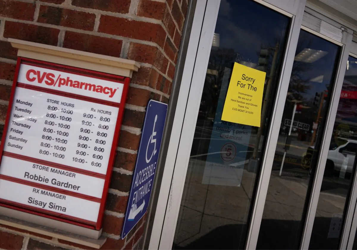 A message is seen on the doors of a CVS pharmacy announces that the store is out of hand sanitizer and gloves in Washington on March 17, 2020. (Mandel Ngan/AFP via Getty Images)