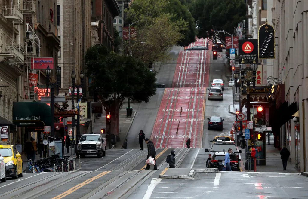 Few pedestrians walk along Powell Street during commute hours on March 16, 2020 in San Francisco, California. Public areas around the country are mostly empty as people around the country are staying away from from large gatherings in an attempt to slow the spread of COVID-19. (Justin Sullivan/Getty Images)